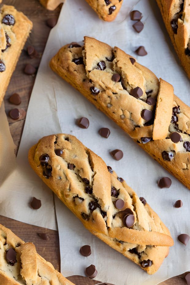 Golden-brown crunchy chocolate chip biscotti, perfectly baked with scattered chocolate chips on rustic parchment paper.