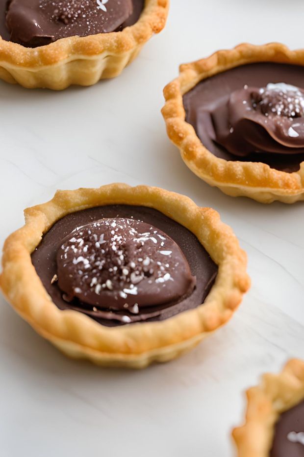 Mexican Chocolate Puff Tarts with rich chocolate filling and flaky outer crust, garnished with sea salt.