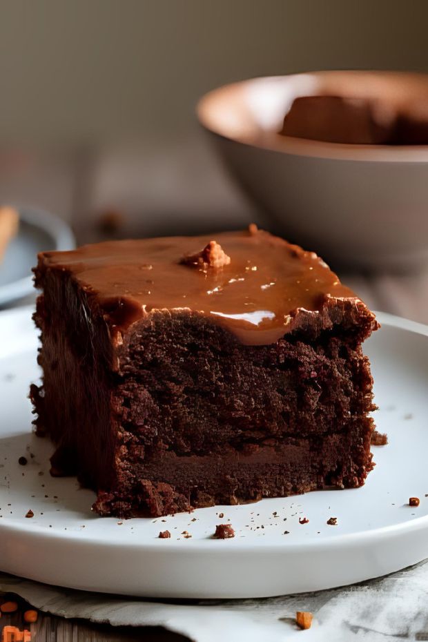 Rich and spicy Chili Chocolate Mayan Cake topped with ganache on a clean white plate.