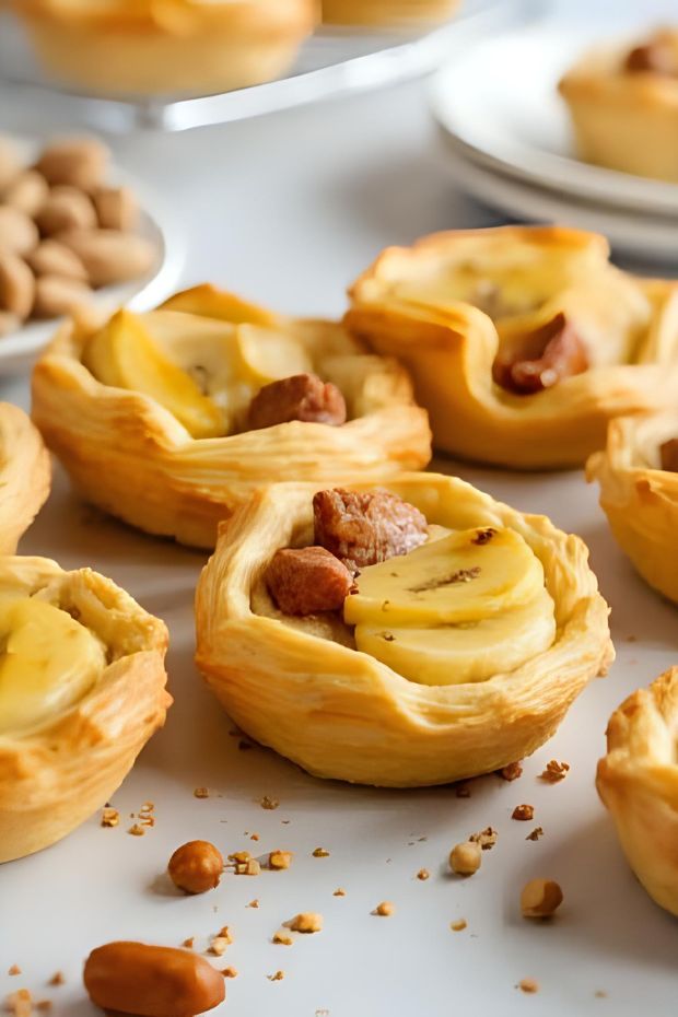 Moist banana nut mini loaf pastries baked in flaky pastry shells, perfect for brunch or dessert.